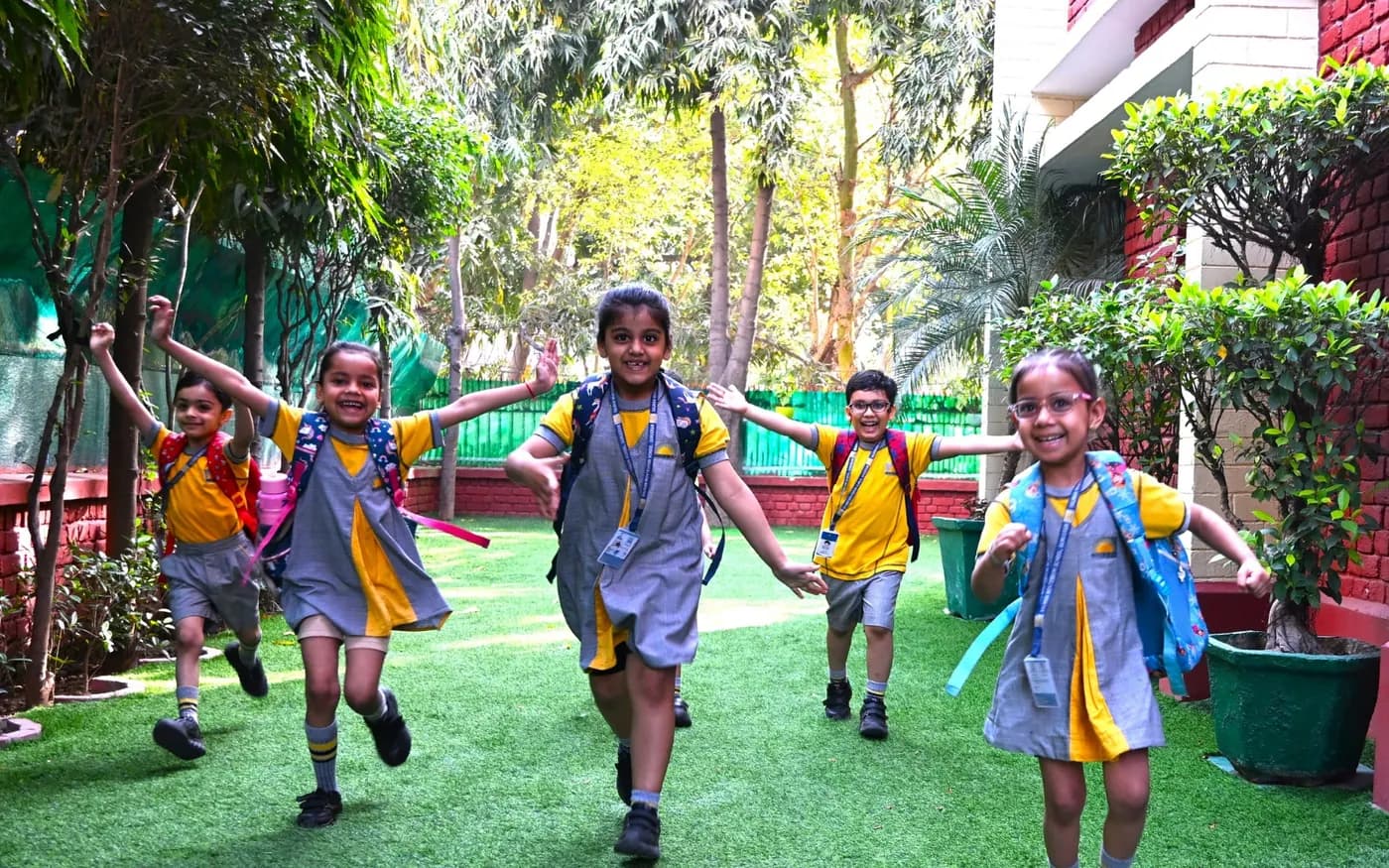 Children enjoying the green play area at Salwan Montessori School