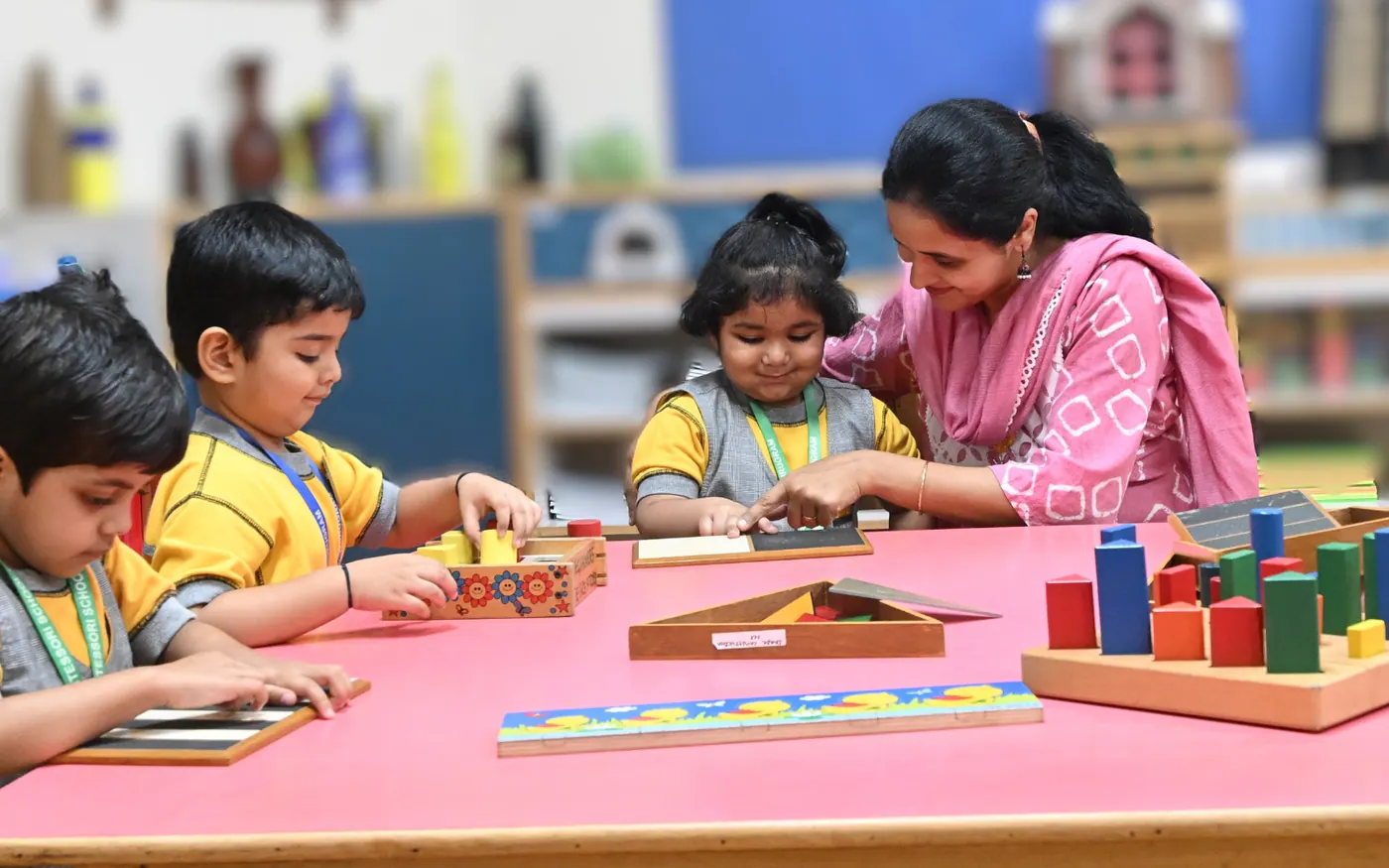 A teacher supporting children during a hands-on learning activity
