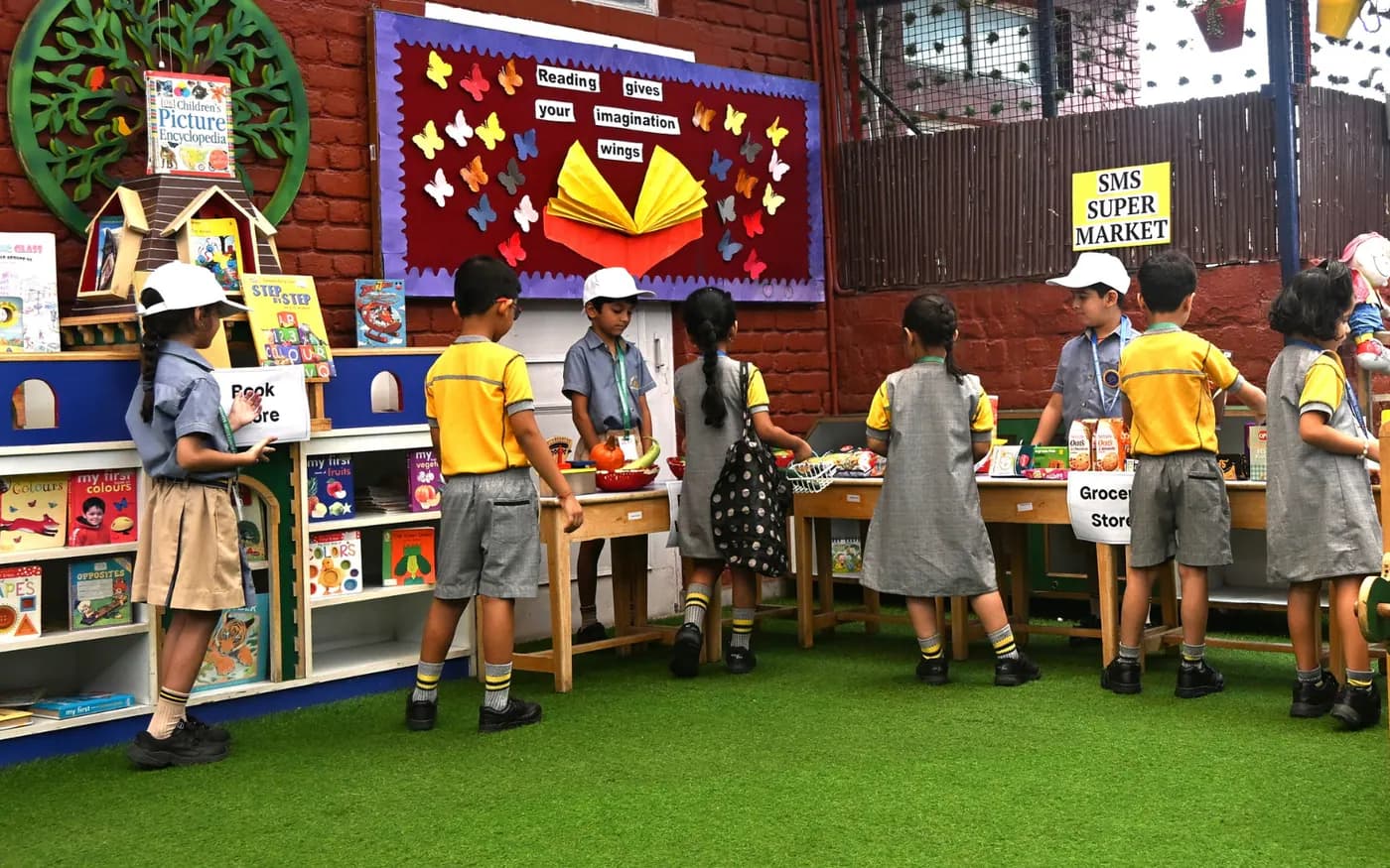 Children exploring learning stations with their teachers
