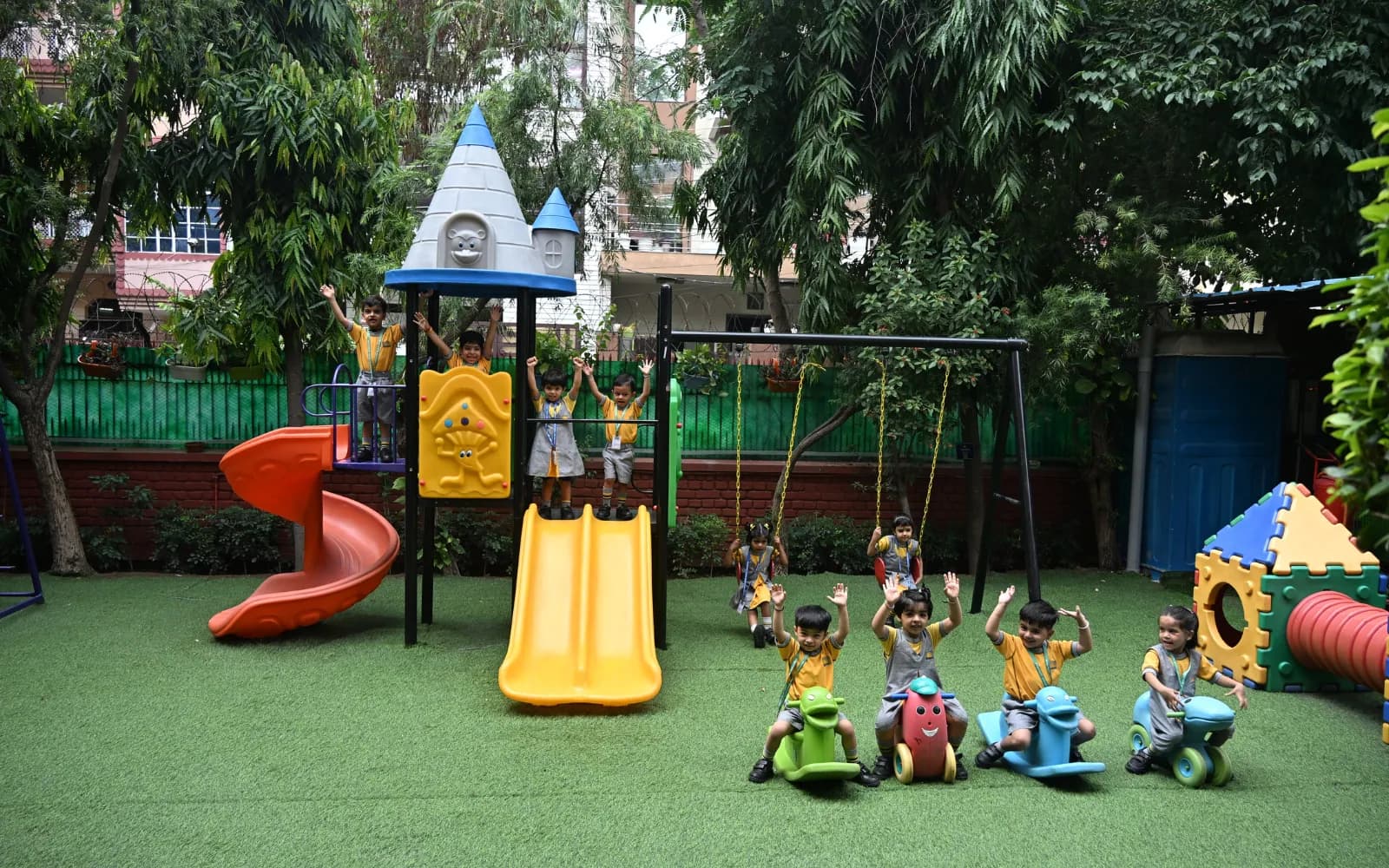 Colourful outdoor play equipment surrounded by trees
